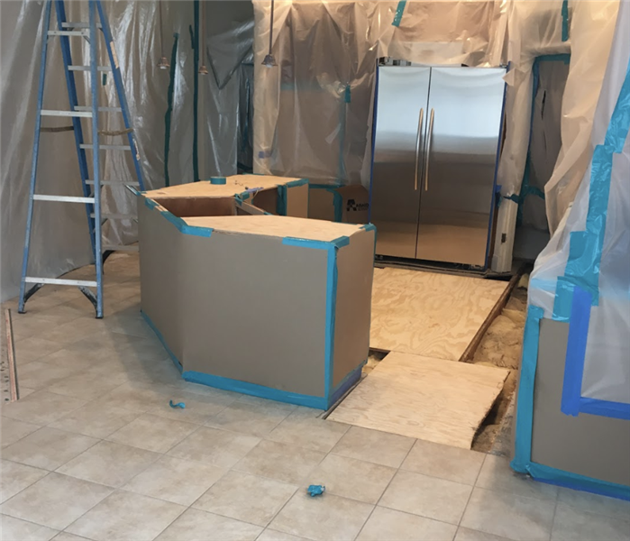 a kitchen with tarping around the cabinets