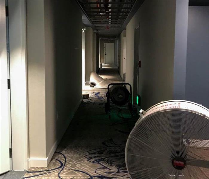 Commercial hallway being dried from water damage. 