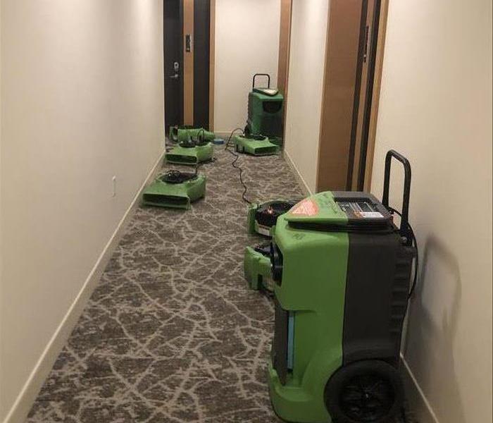 Water damage equipment set up in a commercial hallway.